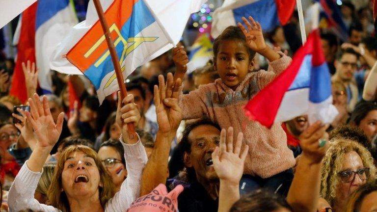 Supporters of Uruguay's presidential candidate Daniel Martinez celebrate in Montevideo