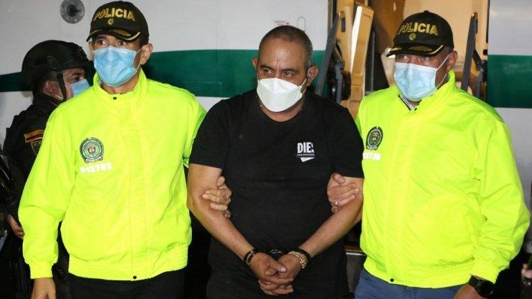 A handout photo made available by the National Police of Colombia shows Dairo Antonio Usug, aka Otoniel, as authorities bring him in to be booked in Bogota, Colombia, 23 October 2021 (issued 24 October 2021).