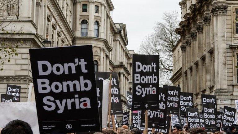 "Don"t Bomb Syria" signs crowd the skyline outside Downing Street against the possible British involvement in the bombing of Syria at Downing Street on November 28, 2015