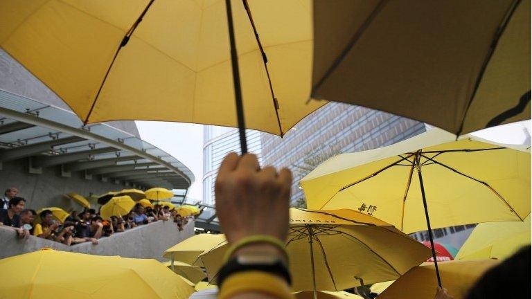 Protesters raise yellow umbrellas hong kong