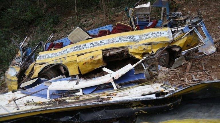 The mangled remains of a school bus are visible after it fell into a gorge near Gurchal village, near Nurpur in Kangra district, India, 10 April 2018.