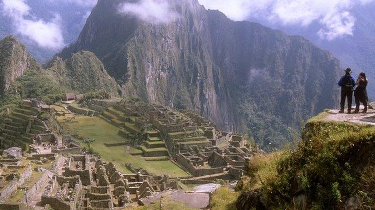 Tourists in the ancient Inca city of Machu Picchu, Peru.