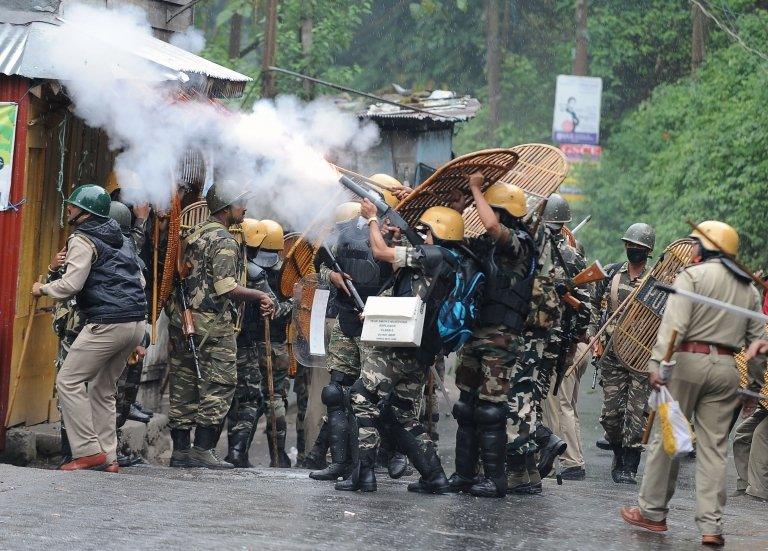 Indian security forces fire tear gas canisters during clashes with supporters of the separatist Gorkha Janmukti Morcha (GJM) group in Darjeeling on June 17, 2017.