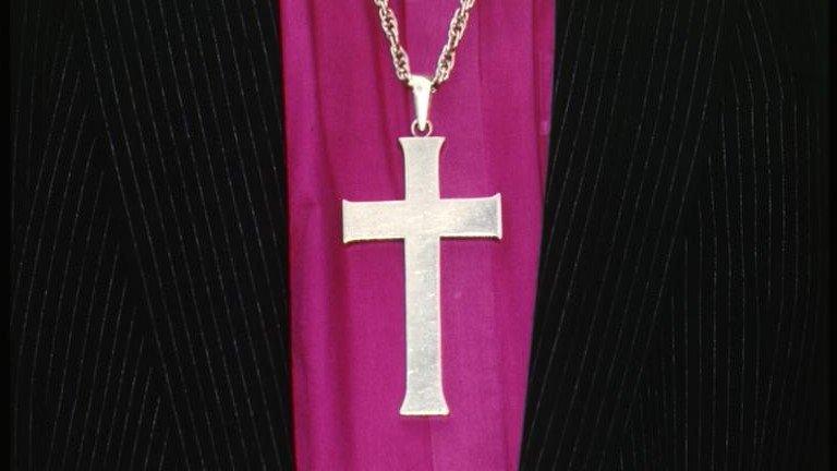 A cross worn on a chain