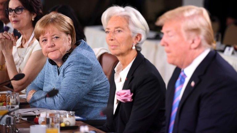 Angela Merkel looks at Donald Trump during G7 talks