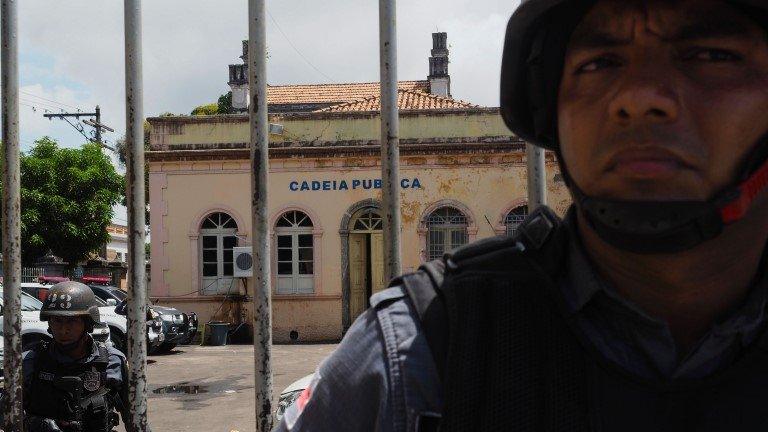 Police officers stand guard at the entrance of the Desembargador Raimundo Vidal Pessoa public jail in Manaus, Amazonas State, Brazil, on January 8, 2017