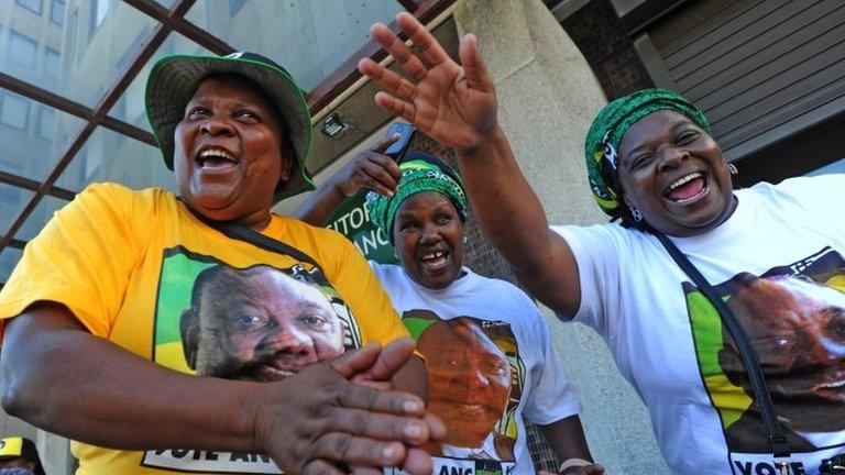 Supporters of the ANC and South Africa's new President Cyril Ramaphosa sing and dance after his swearing in outside the South African general assembly on 15 February 2018 in Cape Town