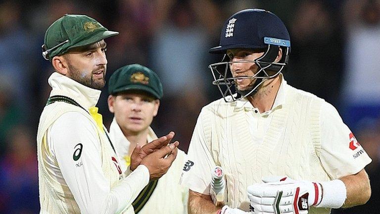 Nathan Lyon applauds Joe Root off at the close of play