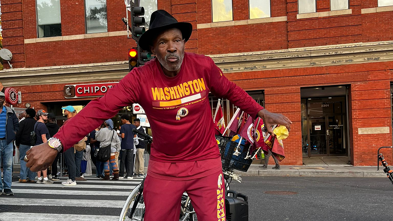 William Ward, 65, wearing a hat and red tracksuit. 