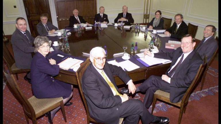 Seated from clockwise at front, SDLP leaders Seamus Mallon, Brid Rodgers and Mark Durgon, Ulster Unionists Sean Farren, Sam Foster and Sir Reg Empey, Sien Fien members Michael McGimpsey, Barbara De Brun and Martin McGuinness with Cabinet Secretary (unamed) and First Minister David Trimble. 