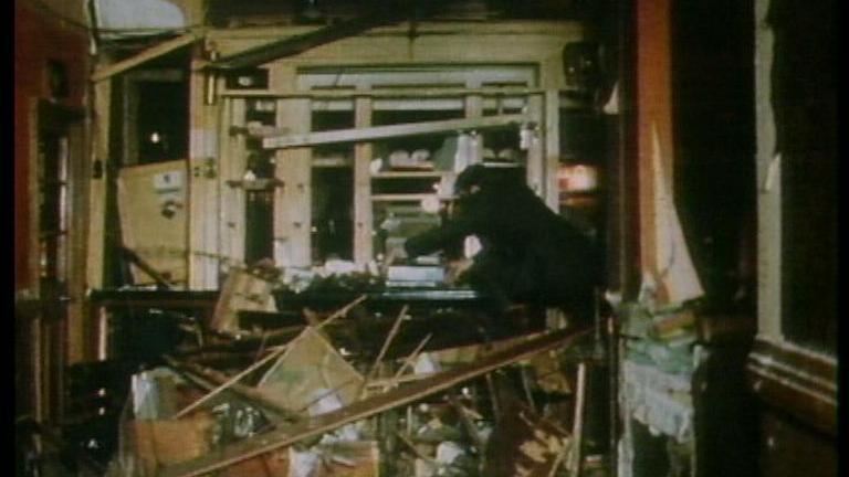 An emergency worker sifts through wreckage at the Seven Stars after the bomb detonated