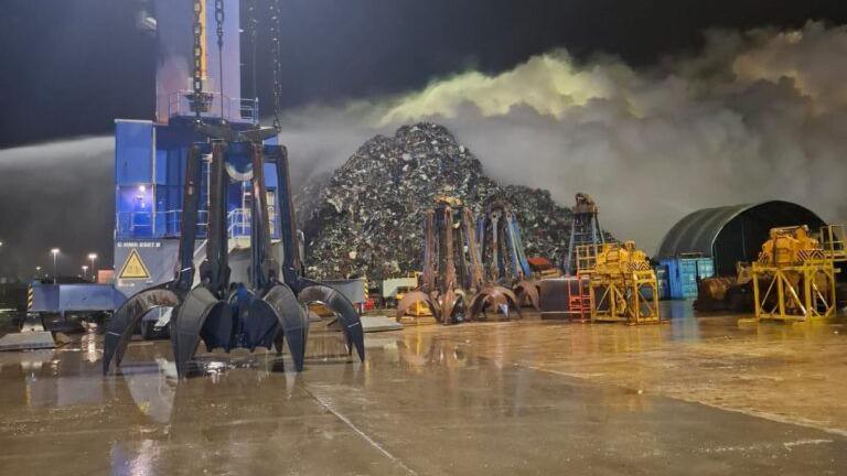 A large pile of scrap metal and smoke at Western Docks