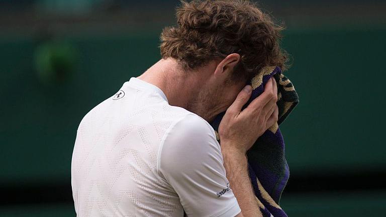 Andy Murray cries into his towel