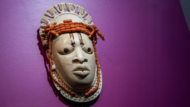 A 19th-century ivory, ceremonial hip mask in honour of Queen Mother Idia and looted by British soldiers from the Kingdom of Benin in 1897 hangs on display in the "Where Is Africa" exhibition at the Linden Museum on May 05, 2021 in Stuttgart, Germany.