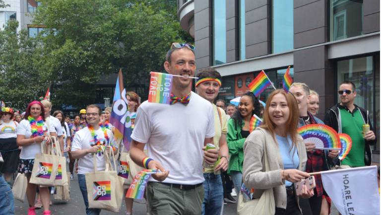 Last year's Reading Pride festival goers marching the streets of Reading holding LGBT flags and bags.