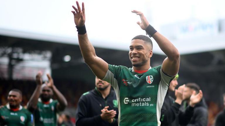 Ben Loader [centre] waves to London Irish fans