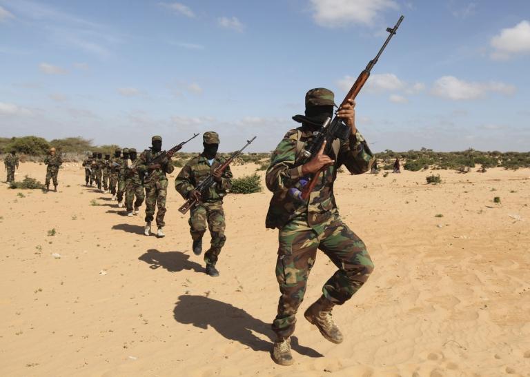 Members of Somalia's al-Shabab militant group parade during a demonstration to announce their integration with al-Qaeda south of the capital, Mogadishu, on 13 February 2012