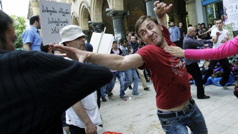 A protester (left) fights with a gay rights activist in Tbilisi, 17 May