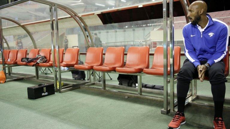 Shanghai Shenhua's player-coach Nicolas Anelka watches his team warming up