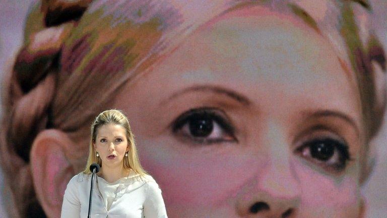 Eugenia Tymoshenko, the daughter of Ukraine's jailed former Prime Minister Yulia Tymoshenko, reads a letter from her mother in front of giant screen displaying a picture of the opposition leader in Kiev