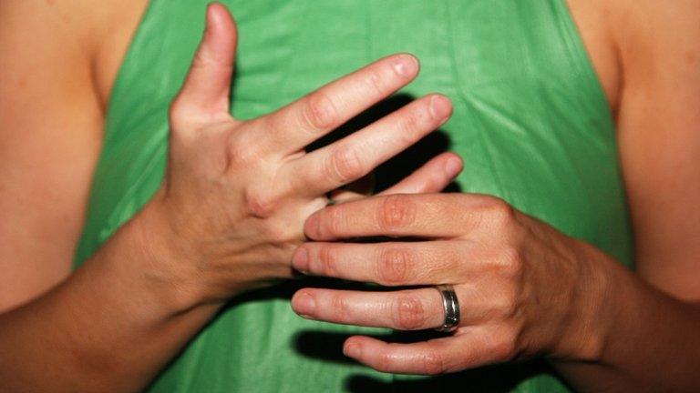 A woman wearing a wedding ring