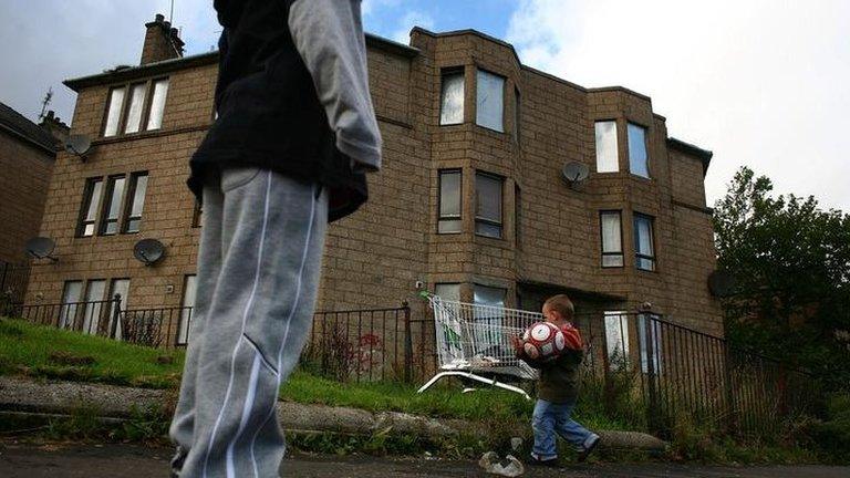 Children playing by boarded-up houses