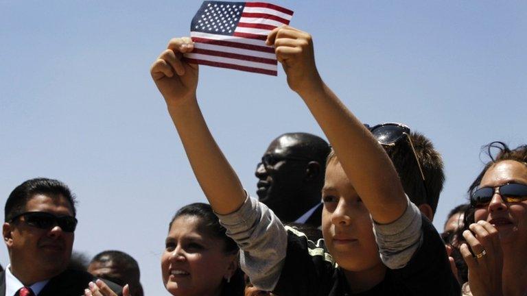 A young boy holds up a US flag at an Obama rally in El Paso, Texas 10 May 2011