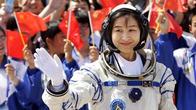 Liu Yang waves during a departure ceremony at Jiuquan Satellite Launch Center, Gansu province, June 16, 2012