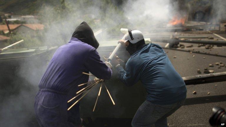 Miners on strike in the northern town of Cinera fire a home-made rocket at police