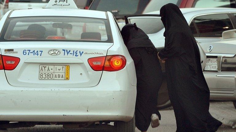 Saudi women get into a taxi outside a shopping mall in Riyadh on June 22, 2012