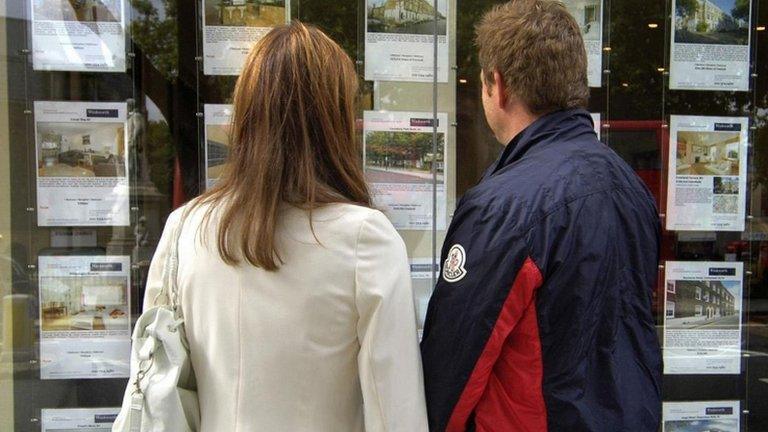 Couple outside estate agent