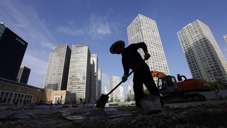 A labourer works at a construction site in Beijing"s central business district 12 July, 2012