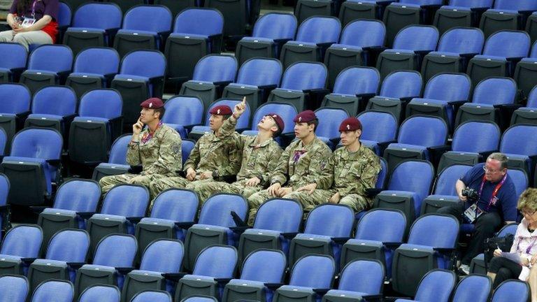 Soldiers sit amid empty seats at London 2012 Olympic Games