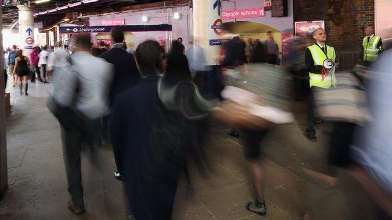 Members of staff provide information to passengers at London Bridge Station, 30 July, 2012