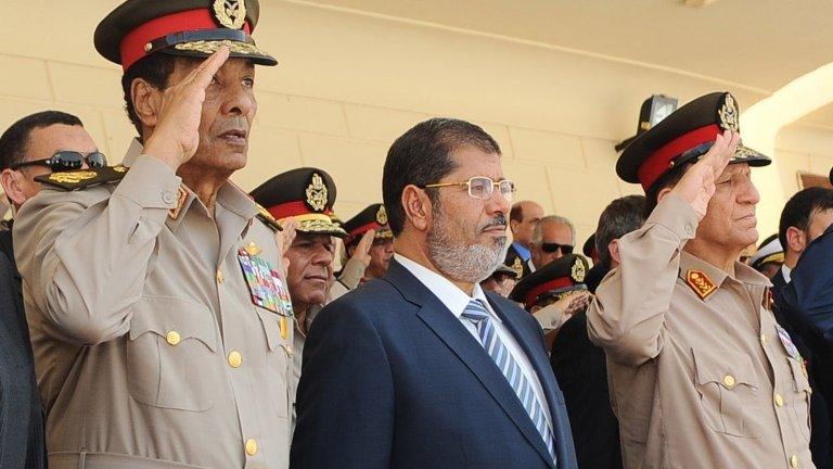 Egyptian President Mohammed Morsi (centre), Field Marshal Mohamad Hussein Tantawi (left) and ex-Chief of Staff Sami Annan