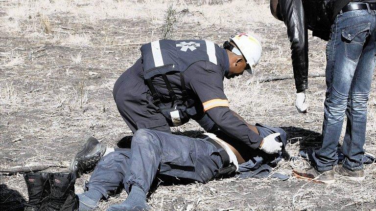Injured policeman is treated after riot at Lonmin mine. 13 Aug 2012