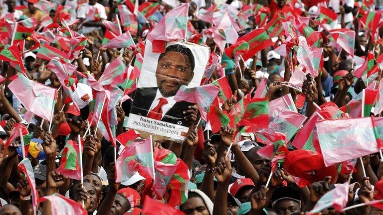 Supporters of Angola's opposition UNITA party with a poster showing their leader Isaias Samakuva during an election rally in Luanda