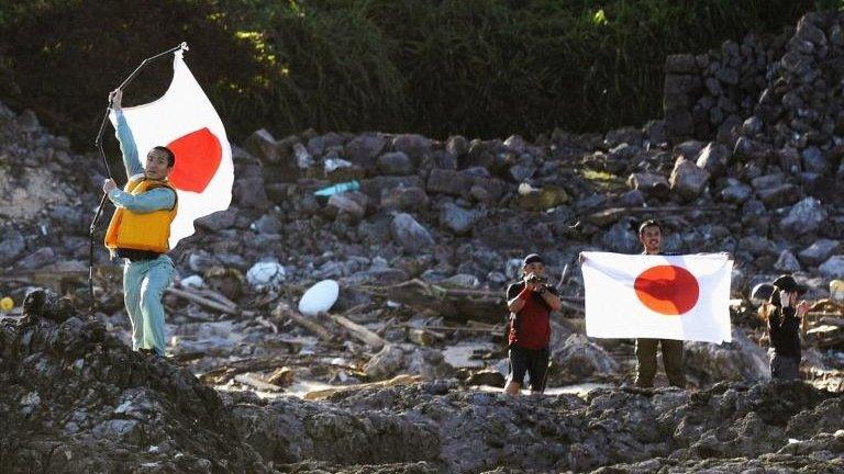 Members of a Japanese nationalist group land on Uotsuri island, part of the disputed islands in the East China Sea, known as the Senkaku isles in Japan and Diaoyu islands in China, in this Kyodo photograph 19 August, 2012