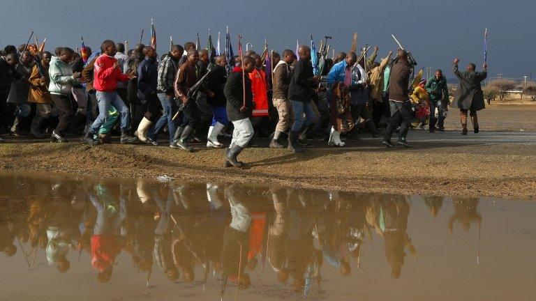 Striking mineworkers march outside Lonmin"s Marikana mine in South Africa"s North West Province as they await the arrival of freed colleagues, September 6 2012.