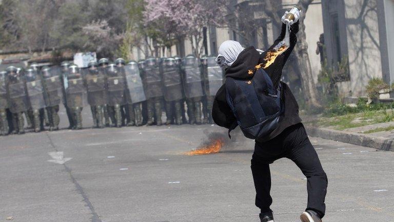 Demonstrator throws Molotov bomb at Chilean police