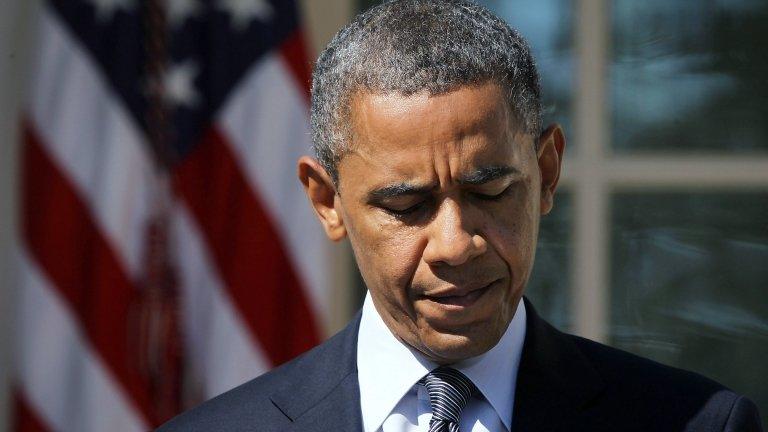 US President Barack Obama pauses as he makes a statement in response to the Benghazi attack, 12 September