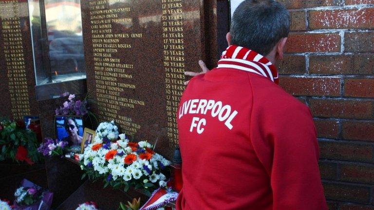 A Liverpool fan pays respects to those who died in the Hillsborough Disaster