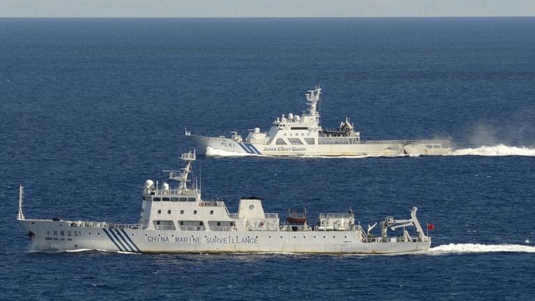 Chinese marine surveillance ship cruising with Japan Coast Guard ship in the background near the disputed islands on 14 September 2012