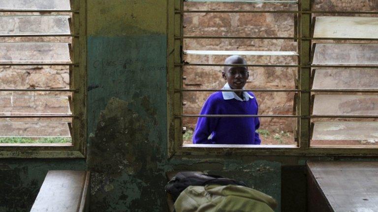 A boy peeps into an empty classroom at his primary school as a nationwide strike by Kenyan teachers demanding a salary increase left most learning institutions paralyzed, in Nairobi September 5, 2012.