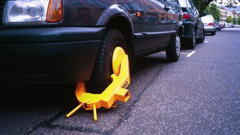 A wheel clamped car