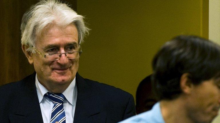 Radovan Karadzic enters the court room to start his defence Oct. 16, 2012