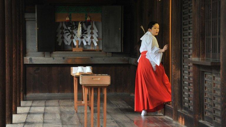 A maiden setting up a reception for visiting Japanese officials at the controversial Yasukuni Shrine in Tokyo, 18 October 2012