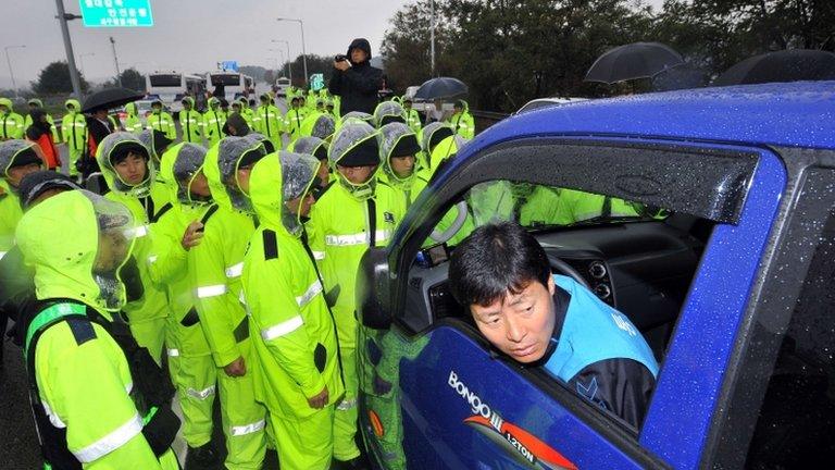 Policemen block a truck carrying leaflets near Paju, South Korea, on 22 October 2012