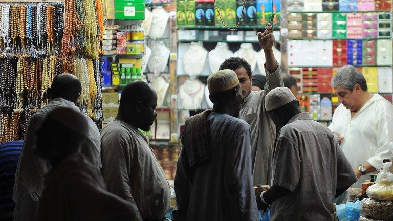 African Muslim pilgrims shop close to the Grand Mosque in the holy city of Mecca, on October 23, 2012.