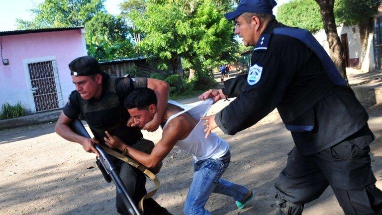 Riot police officers arrest a demonstrator after clashes between supporters of the ruling Sandinista Front (FSLN) and the opposition Independent Liberal Party in La Paz Centro